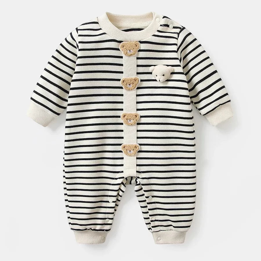 Cream and black striped knit baby romper with teddy bear buttons, flat lay