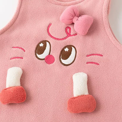 Close-up of the embroidered face, 3D bow and plush feet on the rose fleece romper