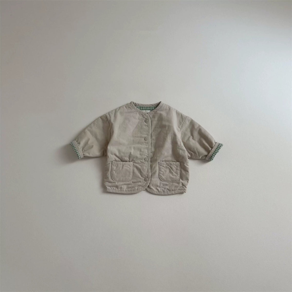 Oat reversible toddler jacket with patch pockets, flat lay