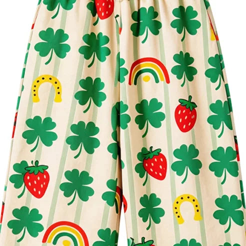 Close-up of green clover, rainbow and strawberry print on cream kids pants