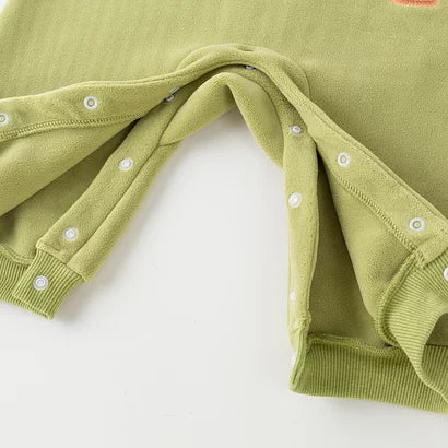 Snap fastening along the legs of the green toddler romper