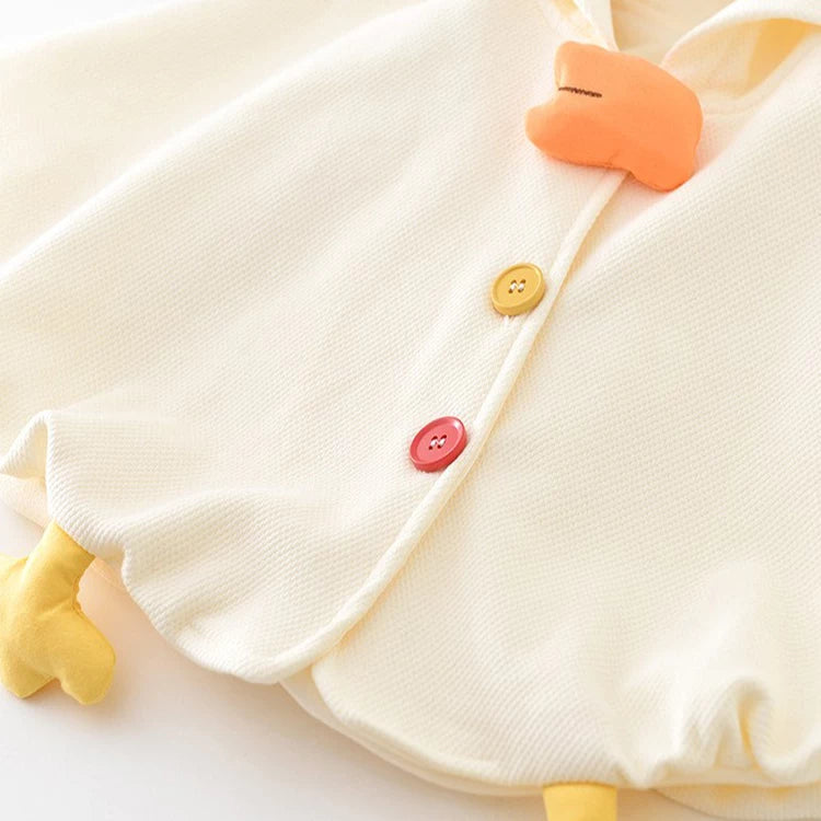 Close-up of chick beak, buttons and little feet on baby cape