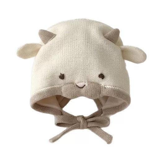 Close-up of cream lamb knit bonnet with embroidered face and lined earflaps