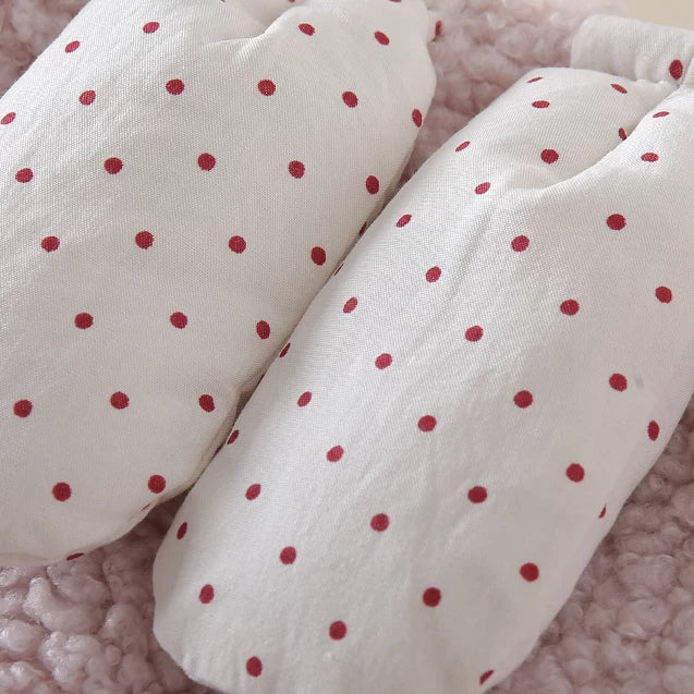Polka-dot bunny toggles on the pink sherpa vest