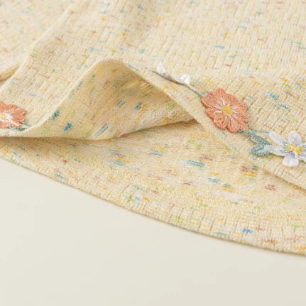 Detail of the curved hem with embroidered floral trim