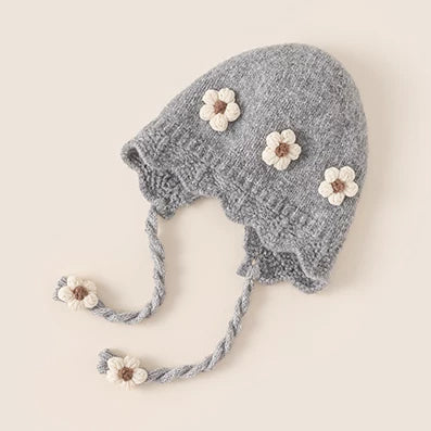Grey knit baby earflap bonnet with crochet flowers and scalloped edge