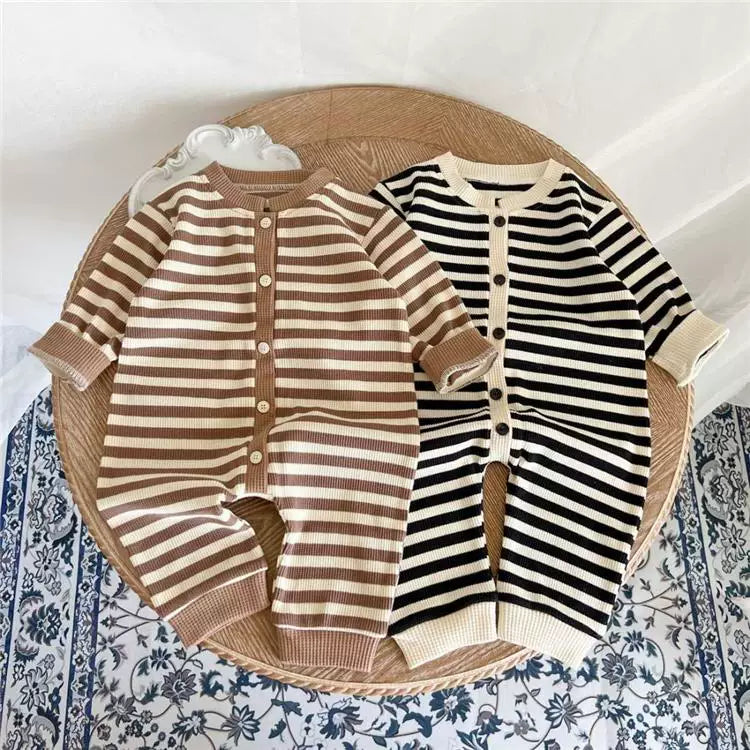 Mocha and ink striped baby rompers laid side by side, flat lay