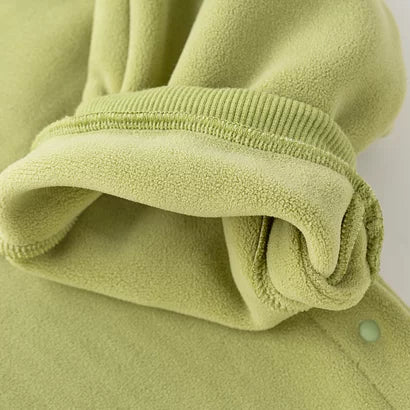 Soft brushed lining inside the ankle cuff of the green romper
