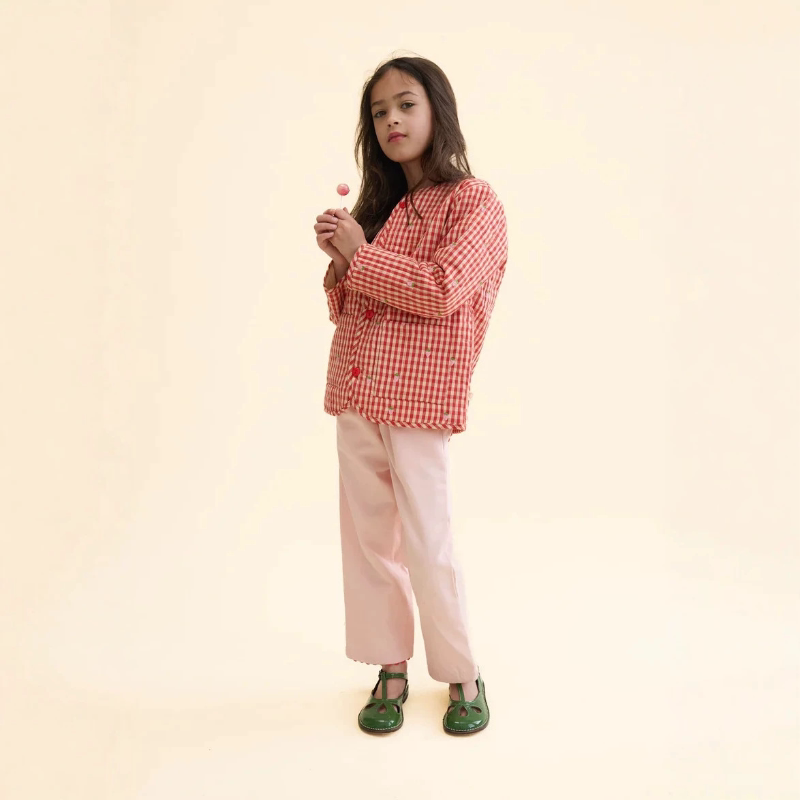 Girl wearing a cherry red strawberry gingham quilted jacket