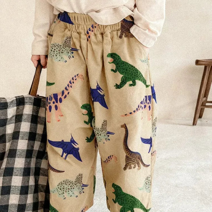 Khaki dino print relaxed wide-leg pants worn with white sneakers