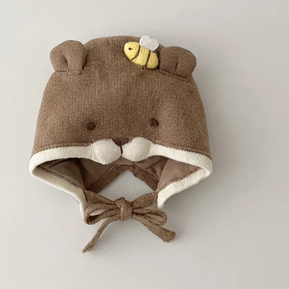 Khaki brown knit bear baby bonnet with little bee, flat lay
