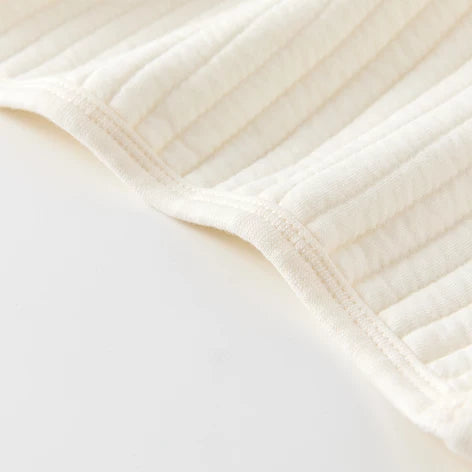 Detail of the soft three-layer quilted cotton and bound armhole