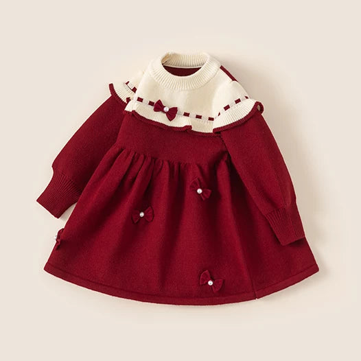 Red and cream knit party dress with bow and pearl details, side view