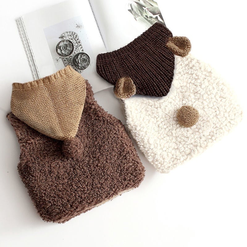 Back of the cocoa and cream sherpa vests with knit hoods