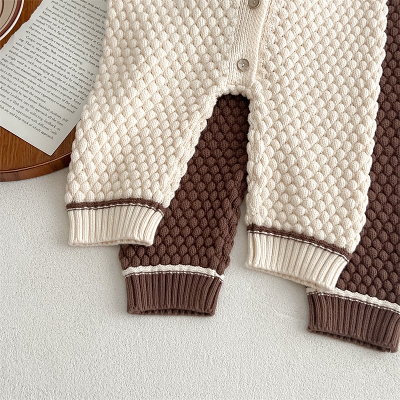 Ribbed ankle cuffs on the cream and brown knit rompers