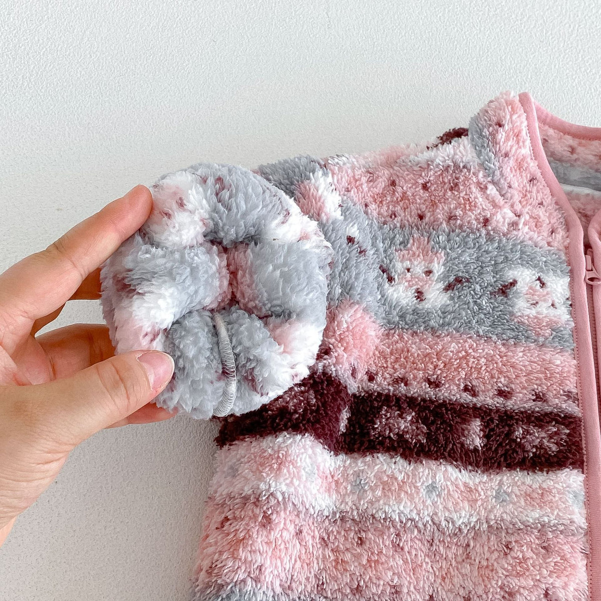 Fluffy fleece cuff and folk pattern detail