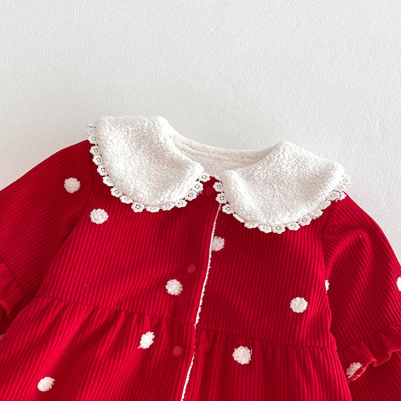 White ruffle collar on red polka dot baby jumpsuit