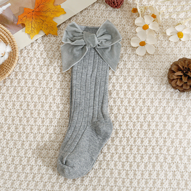 Grey ribbed knee-high baby socks with velvet bow