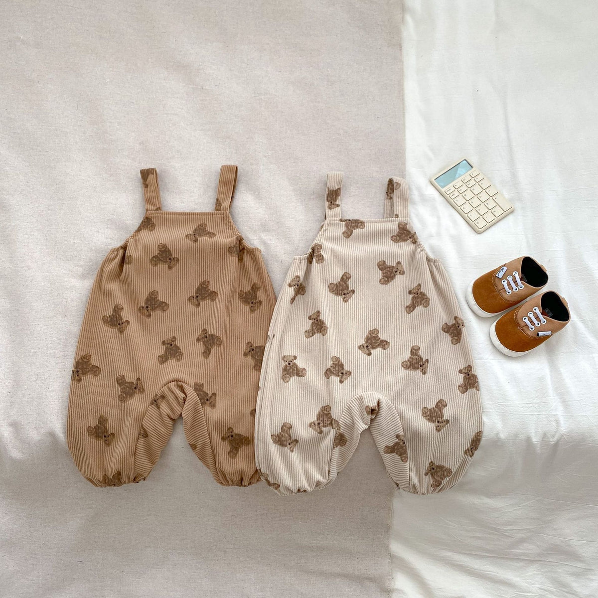 Brown and beige bear print sleeveless baby overalls laid flat