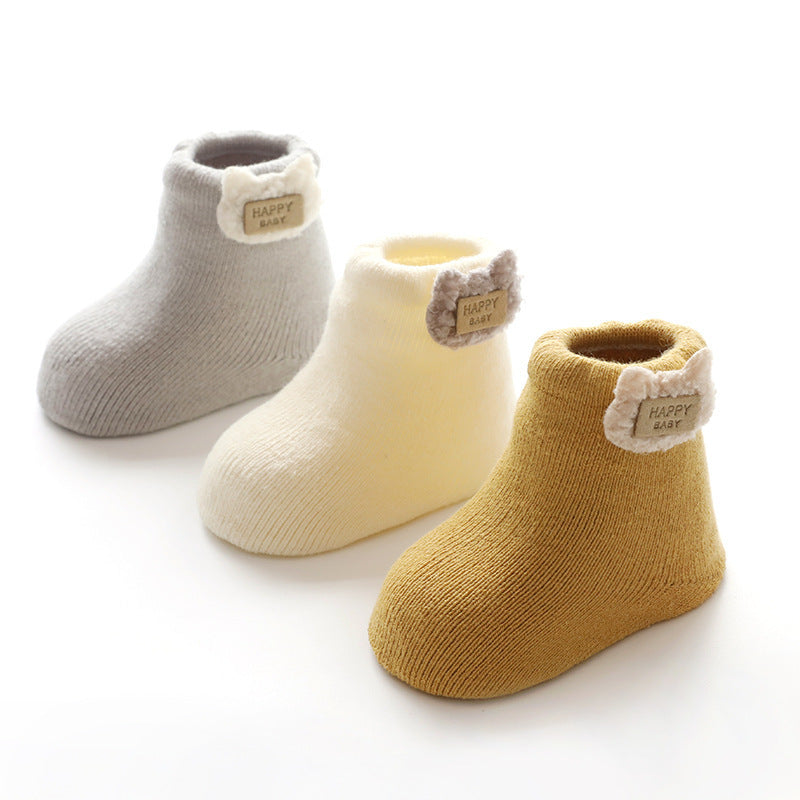 Gray, cream and yellow baby socks with bear tags