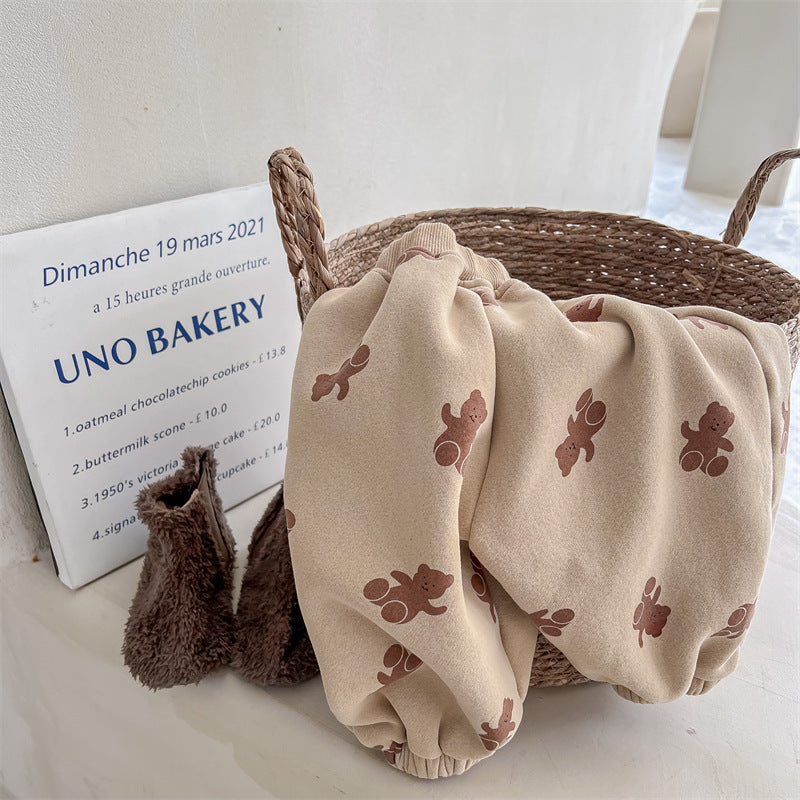 Beige bear print thermal pants in a basket