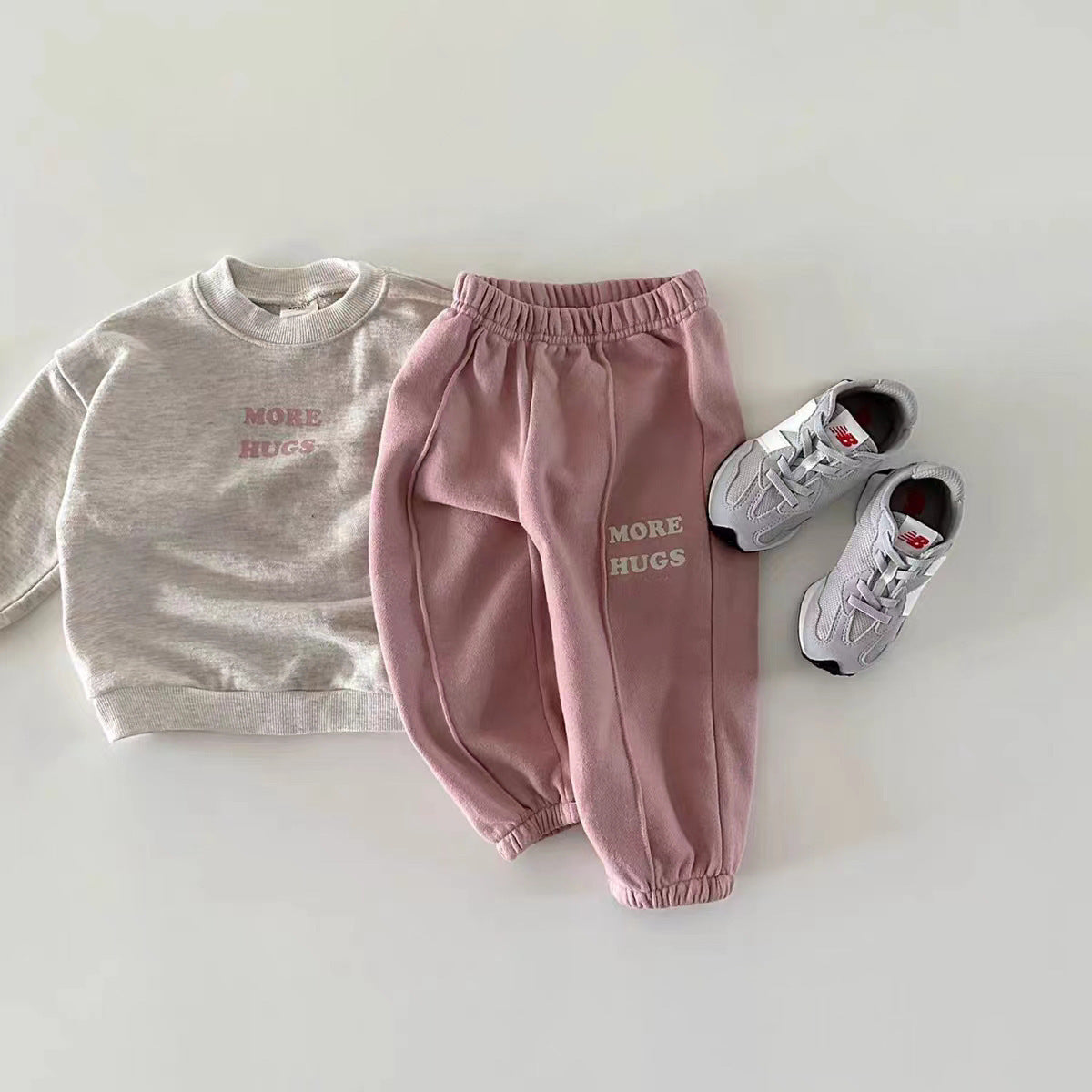 Beige sweatshirt and pink joggers set styled with sneakers