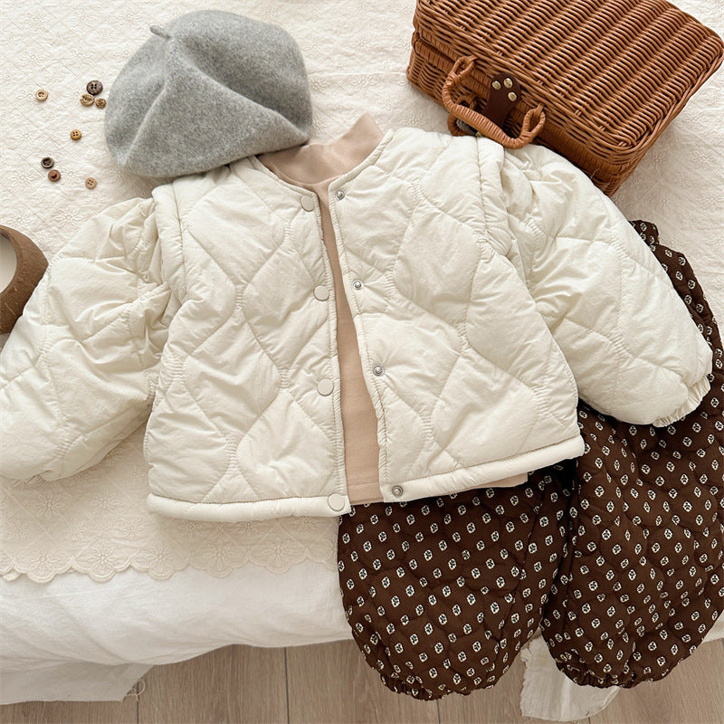 Beige quilted jacket styled with hoodie and pants