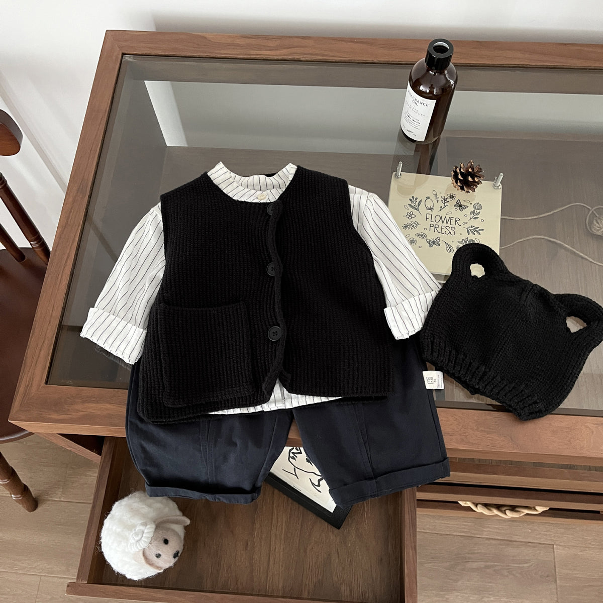 Black knitted vest with white shirt and shorts