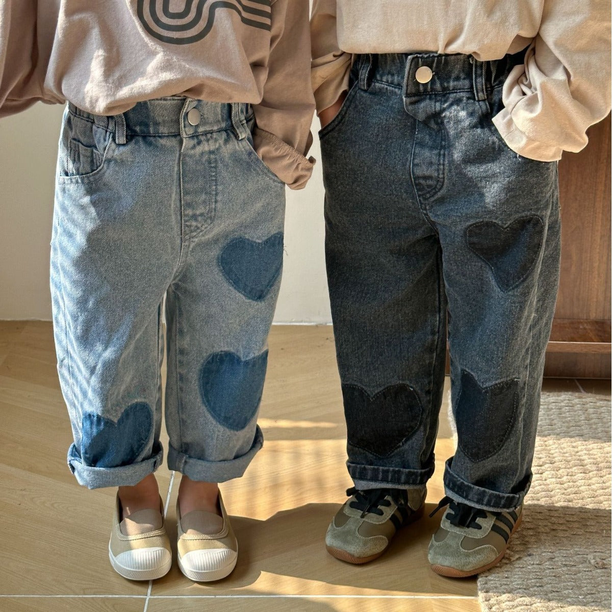 Front view of blue and black heart patch jeans on kids