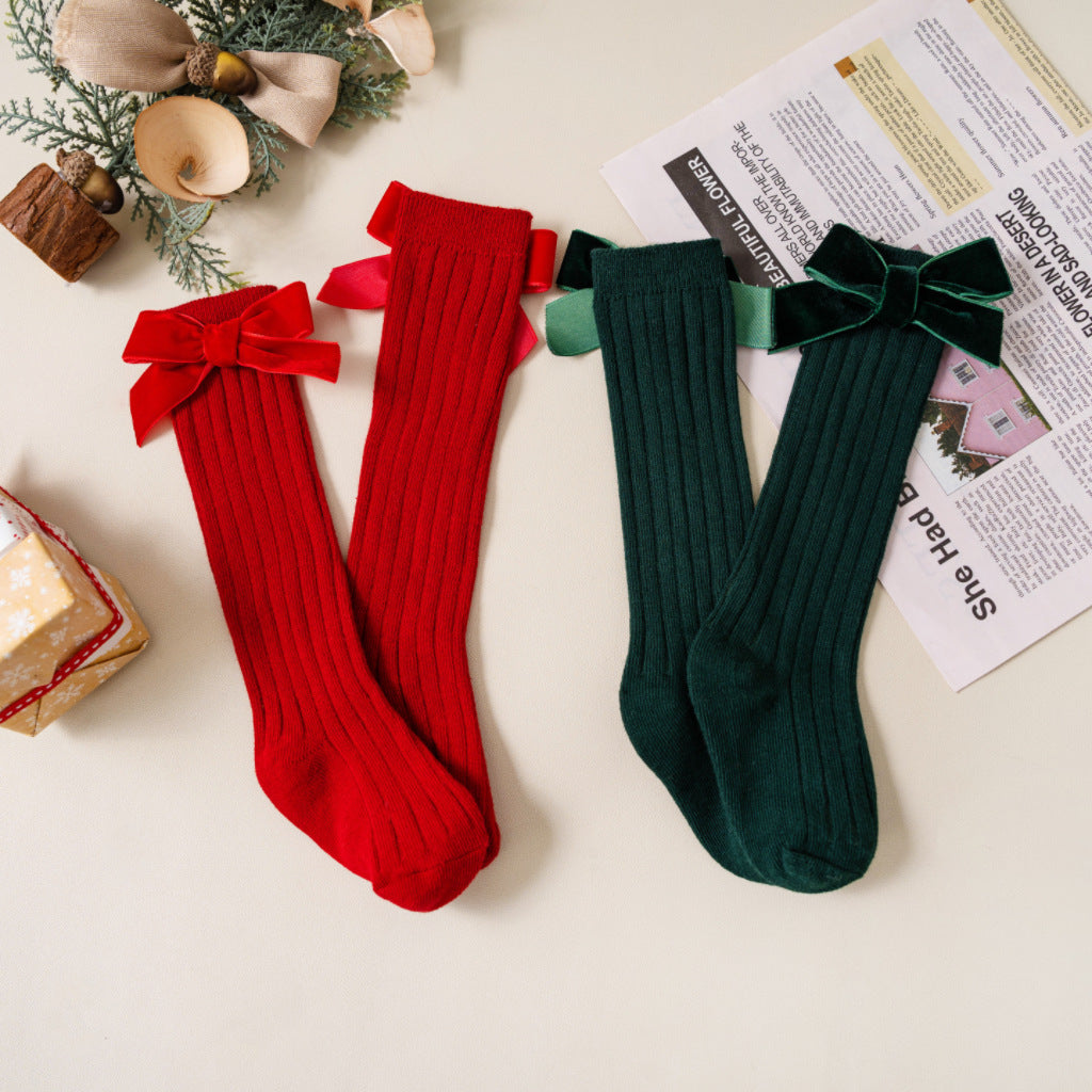 Two pairs of red and green velvet bow knee socks