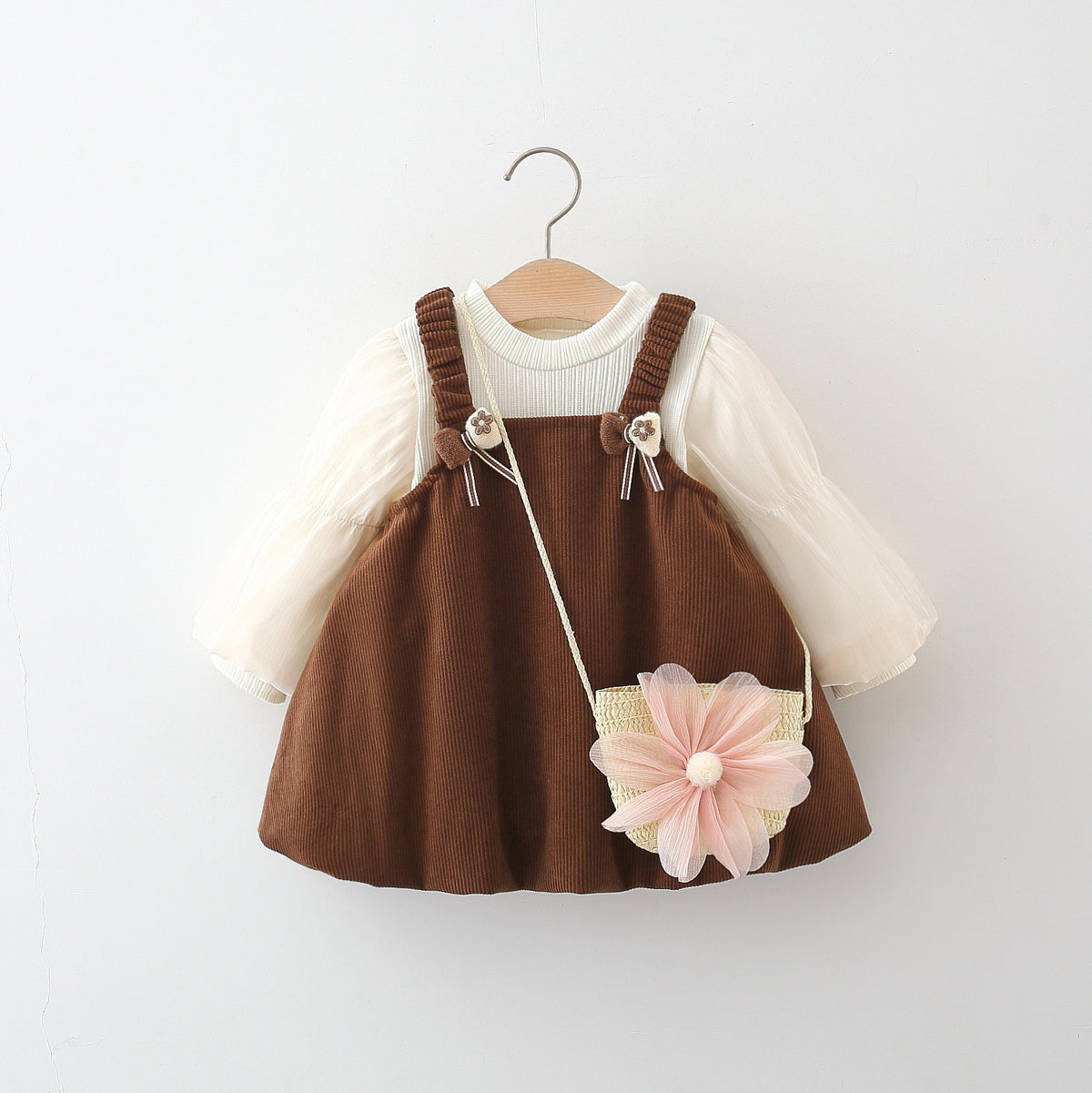 Brown corduroy pinafore suspender skirt with cream puff sleeve top and flower bag