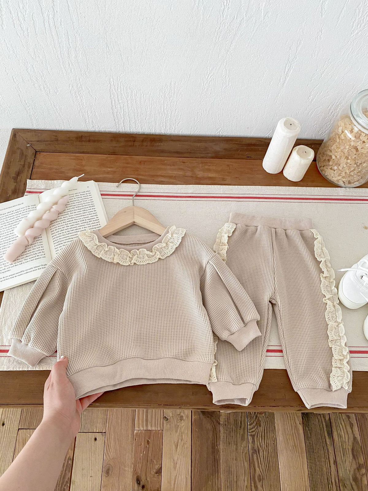 Brown knit sweater and jogger set with frill trim on hangers