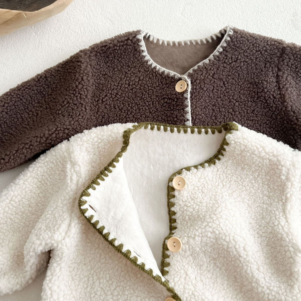 Close-up of brown and white sherpa rompers