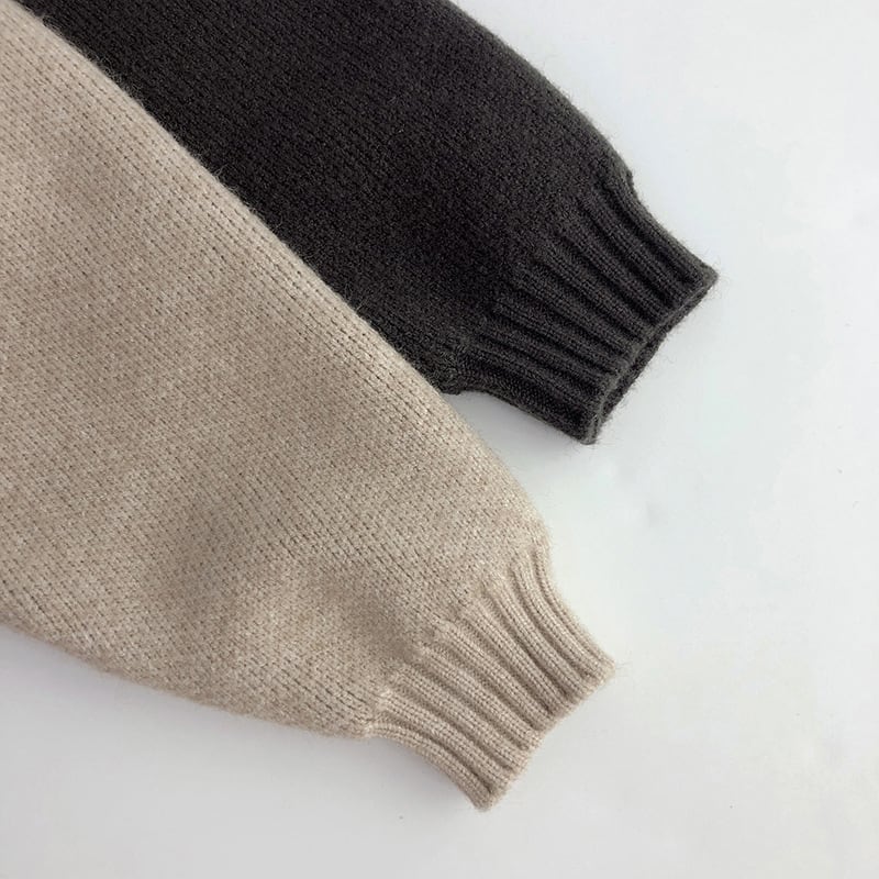 Ribbed cuffs on the oatmeal and charcoal bear knits