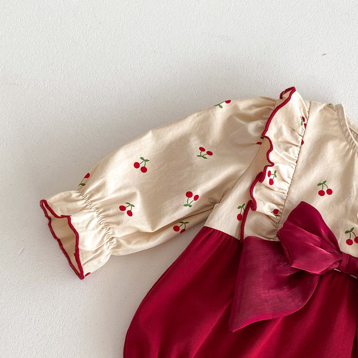 Close-up of sleeve with red frilled cuff