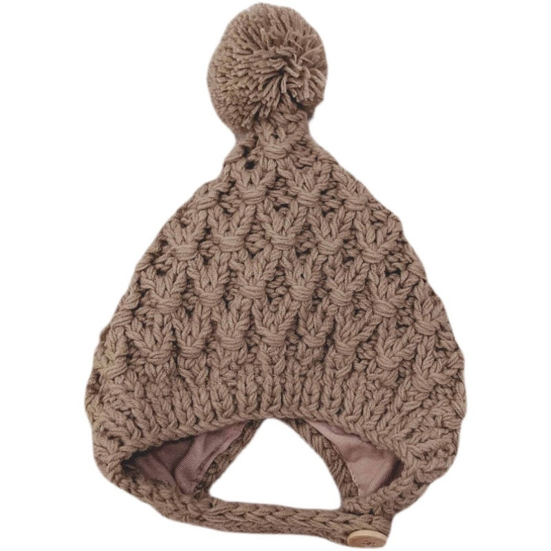 Taupe chunky knit pom-pom bonnet on white background