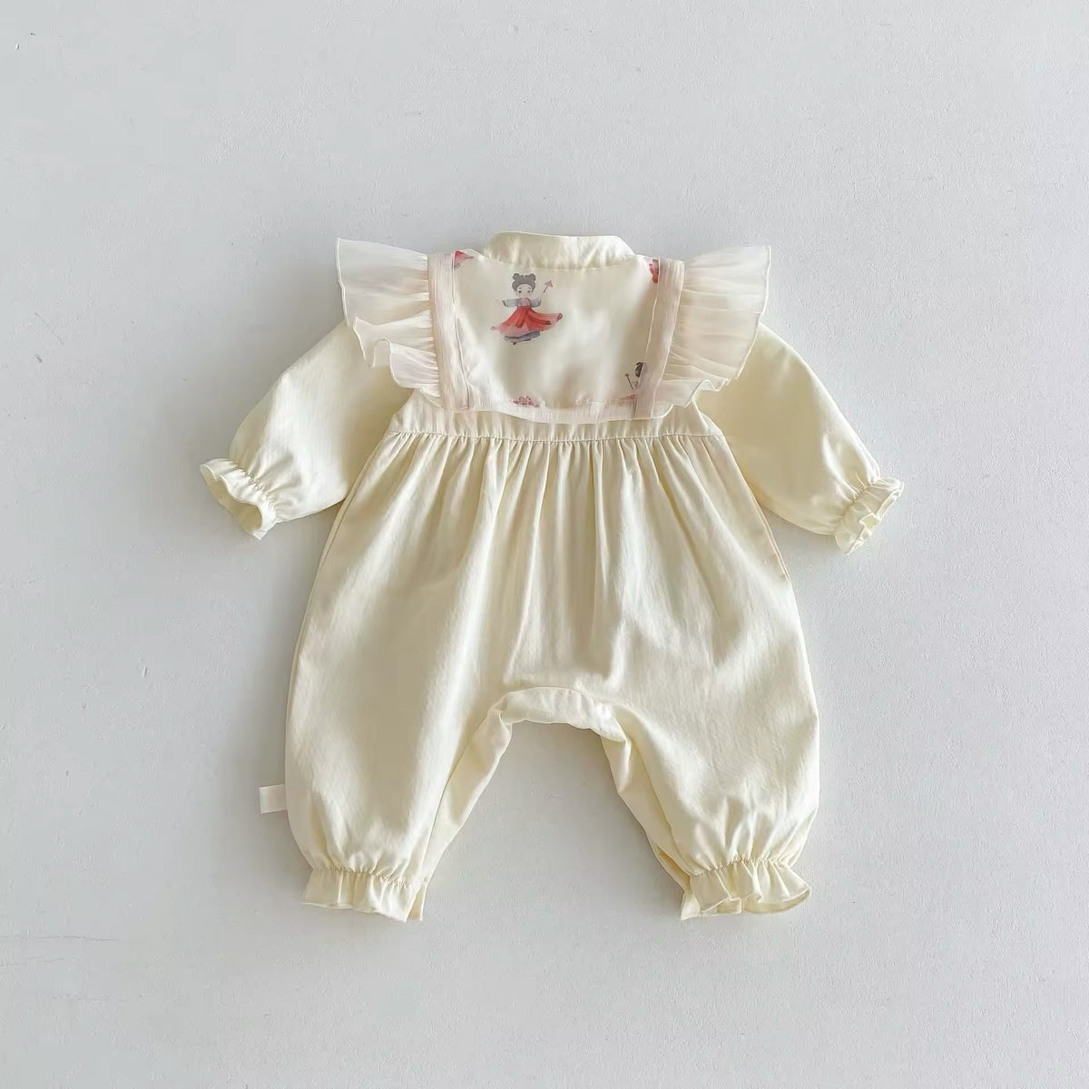 Back view of cream ruffle baby jumpsuit