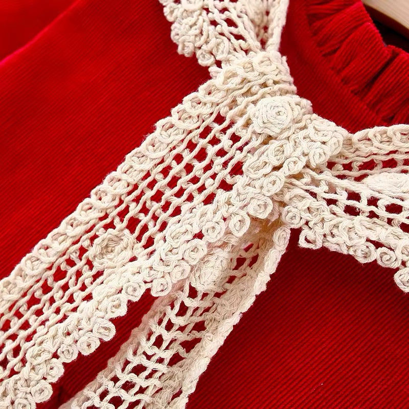 Close-up of cream crochet lace collar on red dress