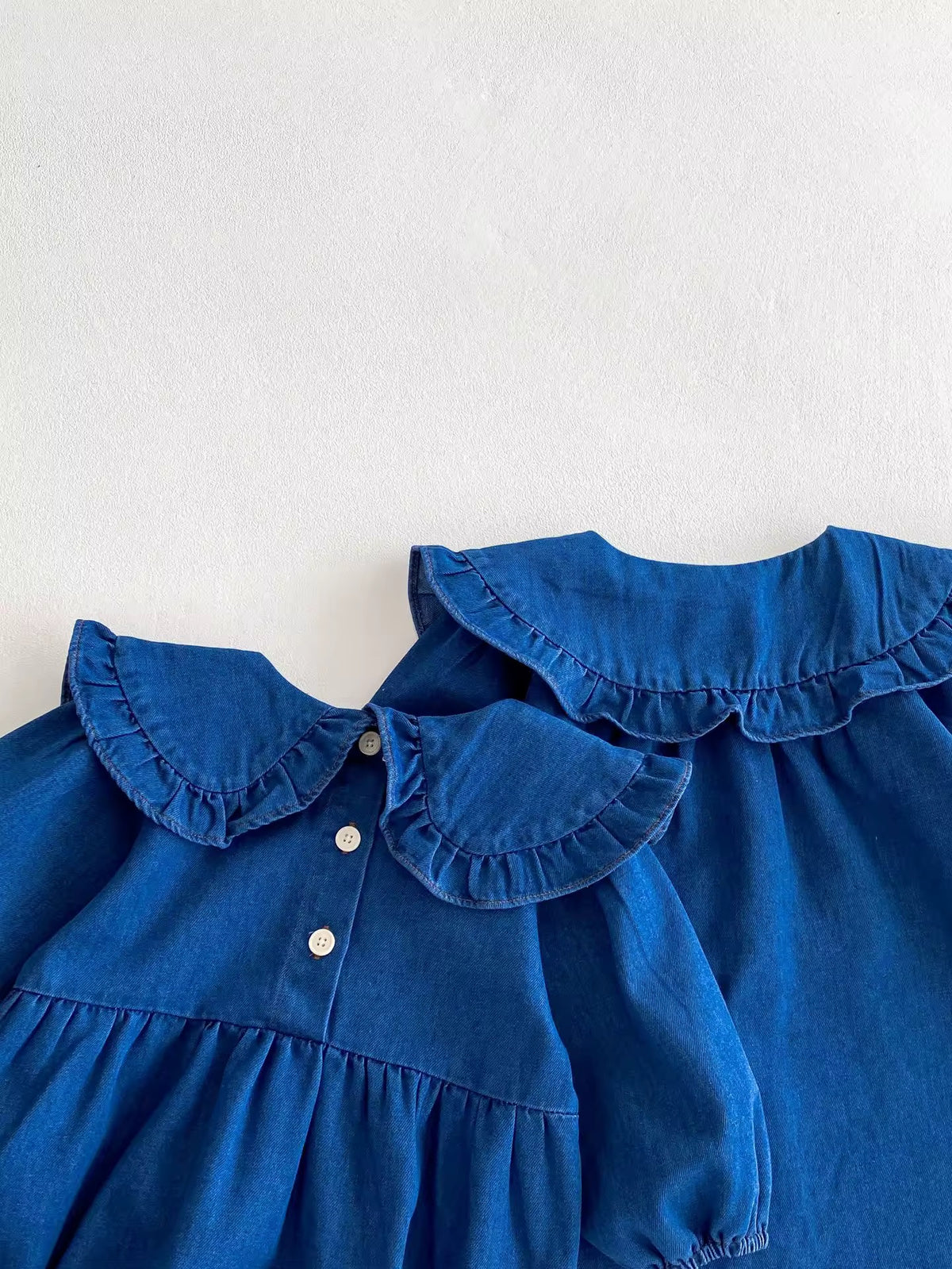 Denim romper and dress layered showing ruffle collars