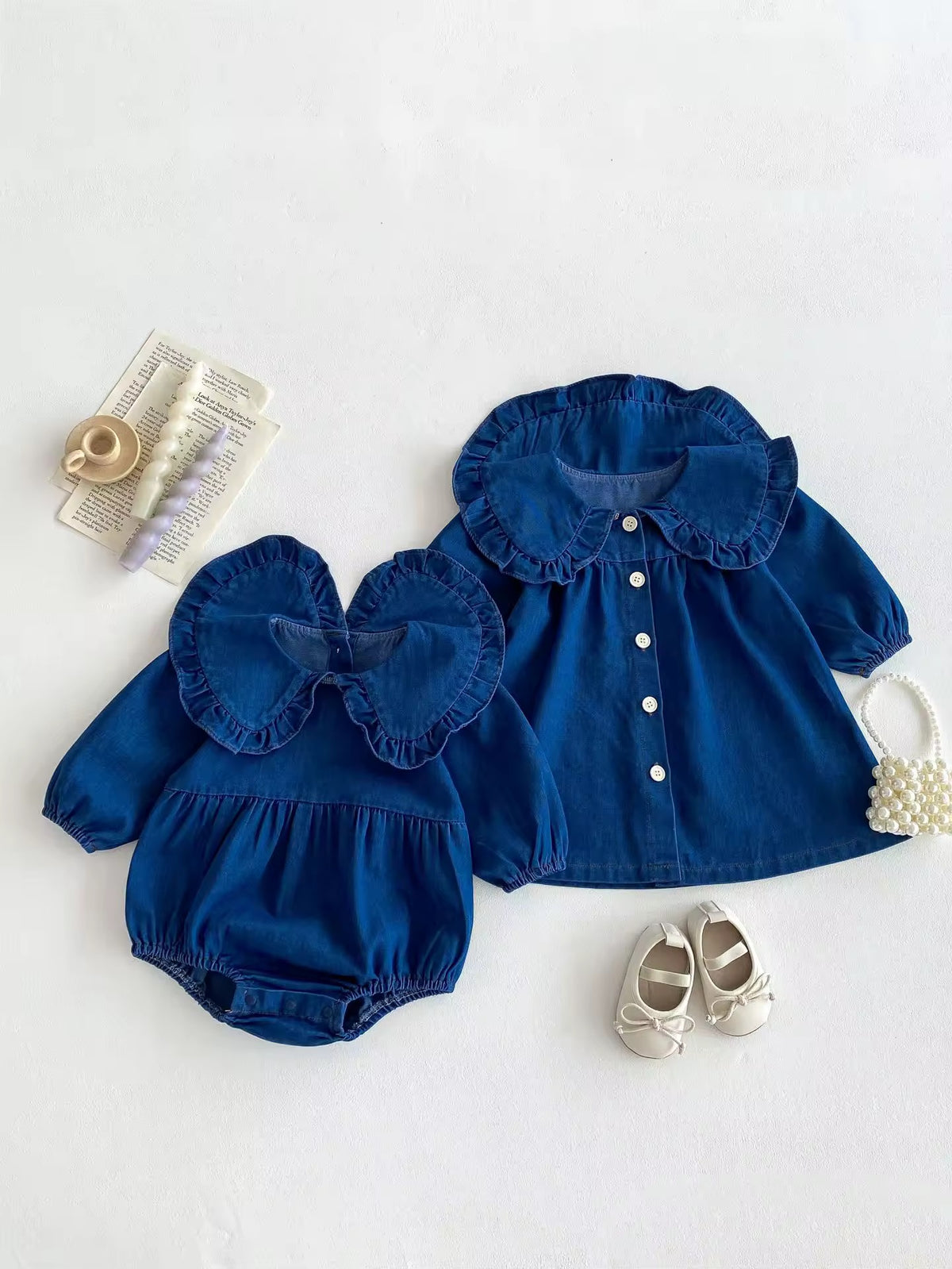 Blue denim ruffle collar baby romper and button-front dress set, flat lay