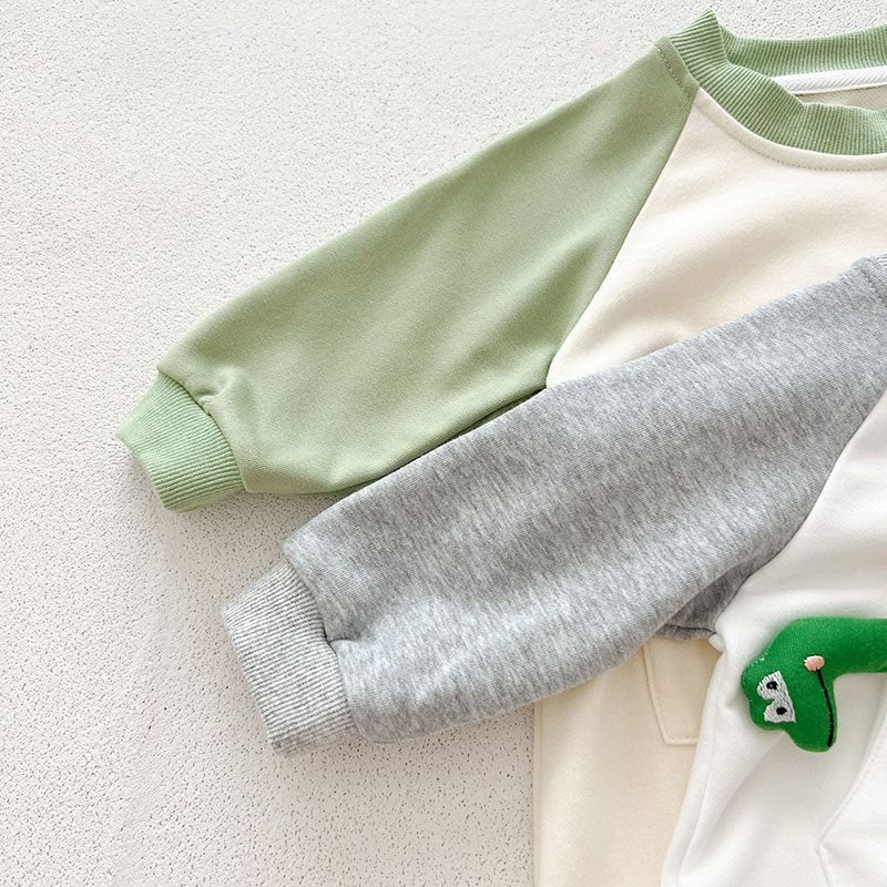 Close-up of green and gray raglan sleeves