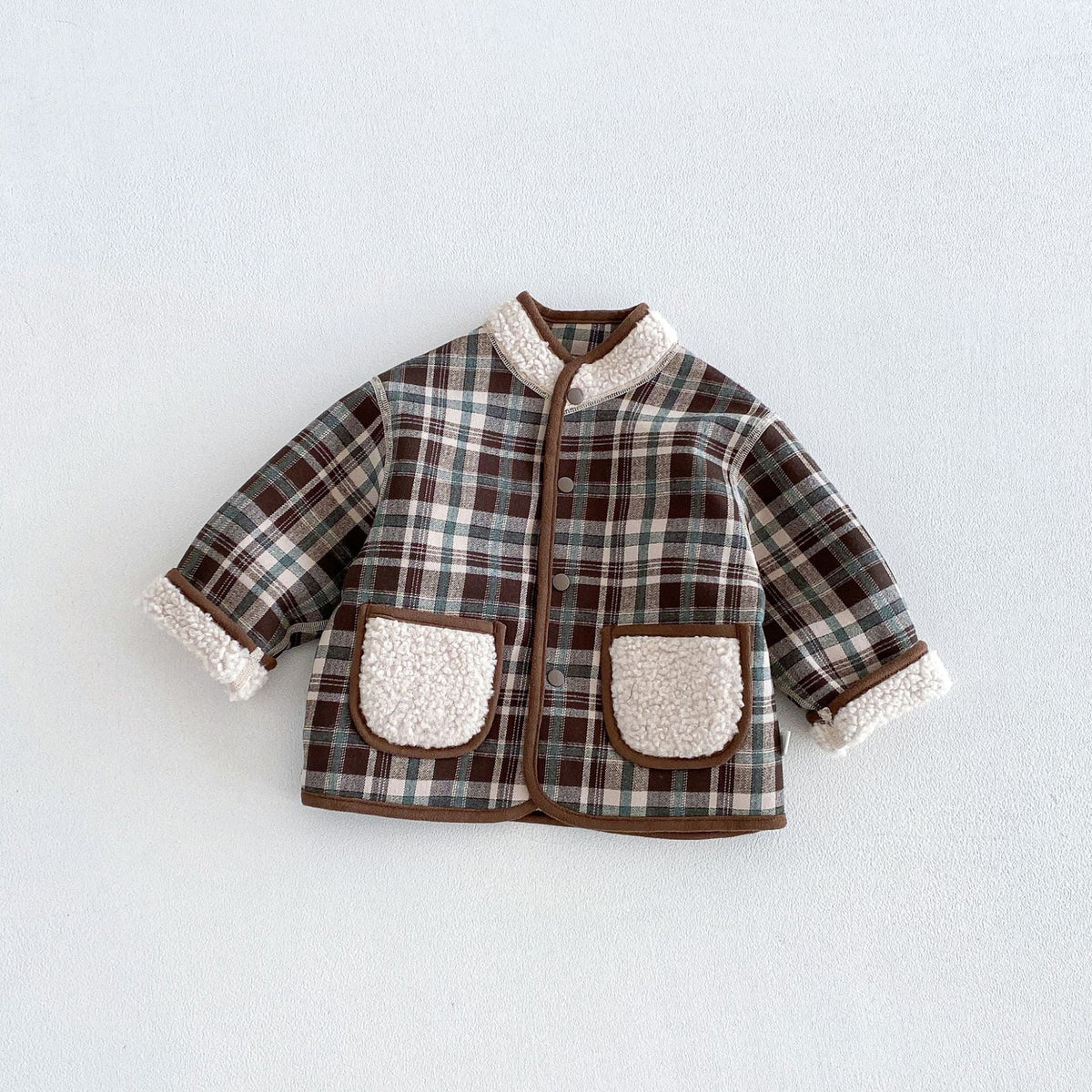 Forest plaid side of the reversible toddler jacket with sherpa pockets and collar