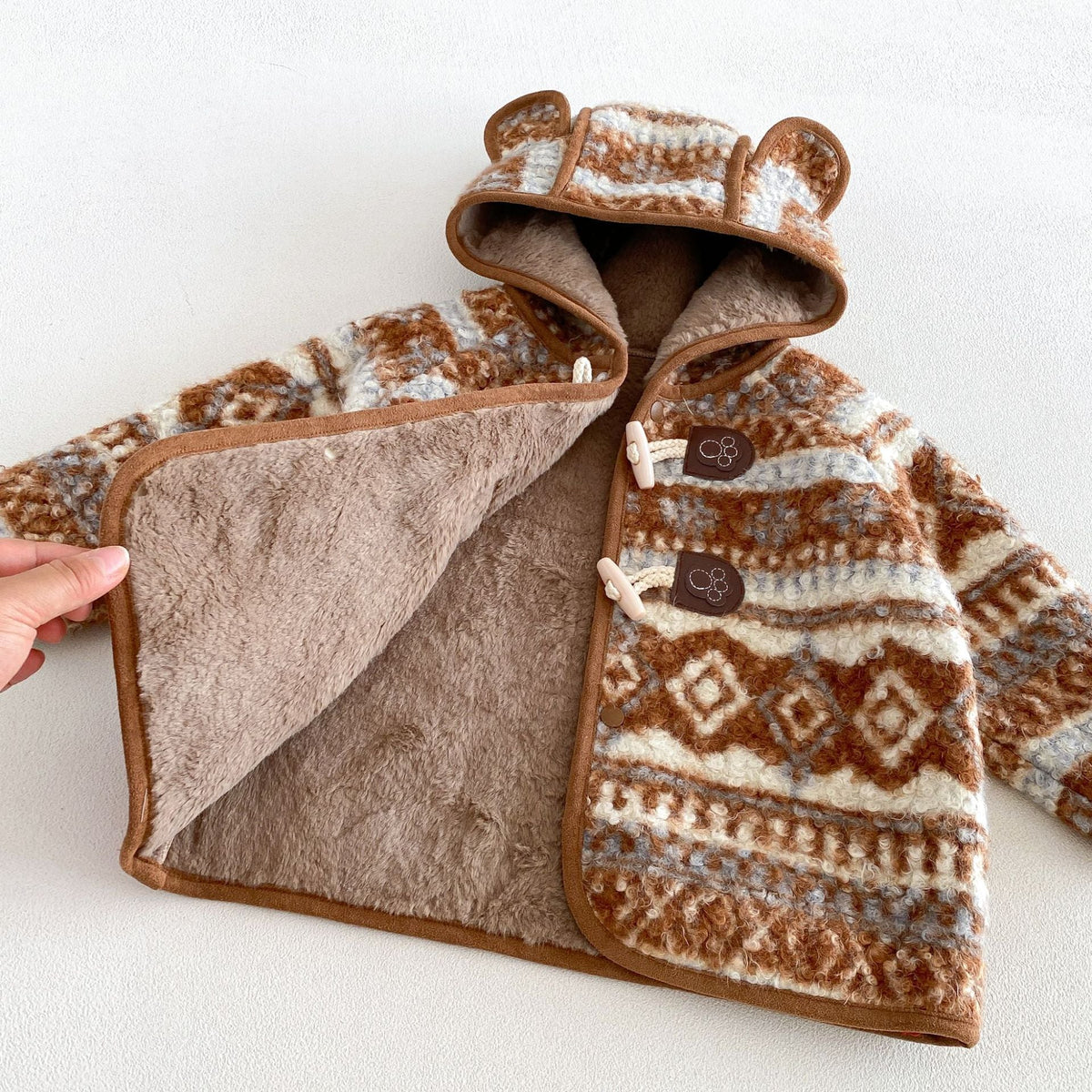 Open fair isle duffle coat showing the soft plush lining