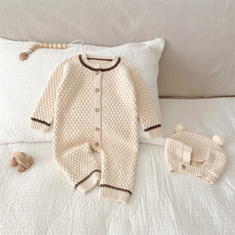 Cream knit baby romper with brown trim and button front