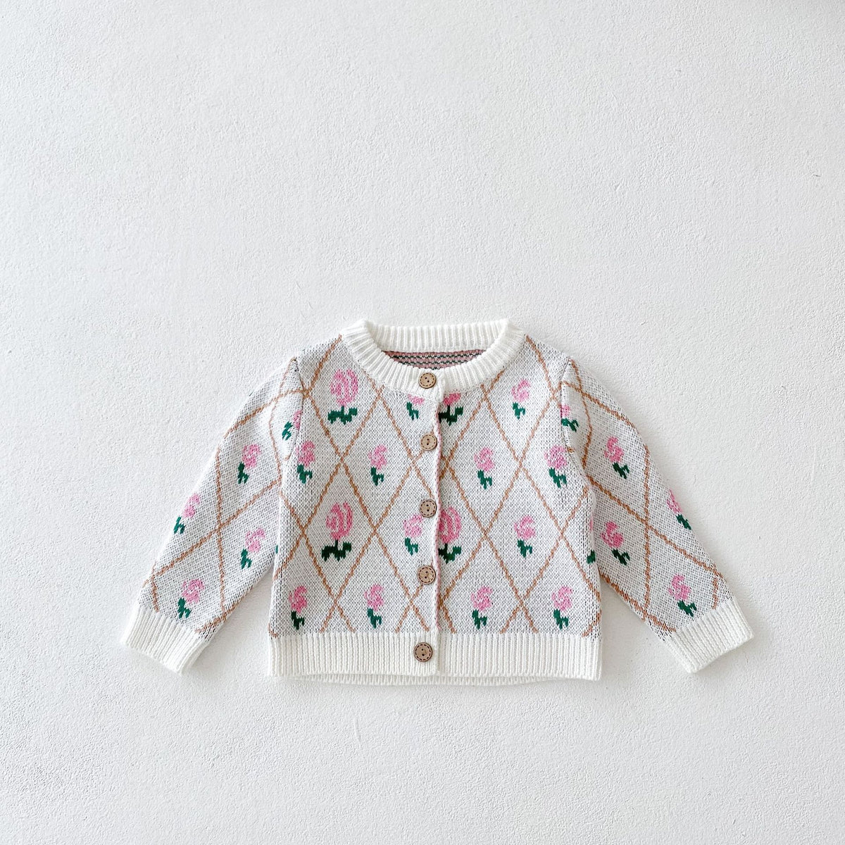 Cream knit baby cardigan with pink rose and diamond jacquard pattern