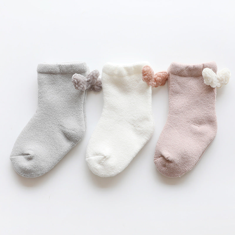 Gray, white and pink baby socks with wing details