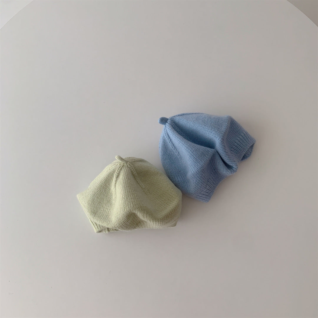 Side view of green and blue knitted berets