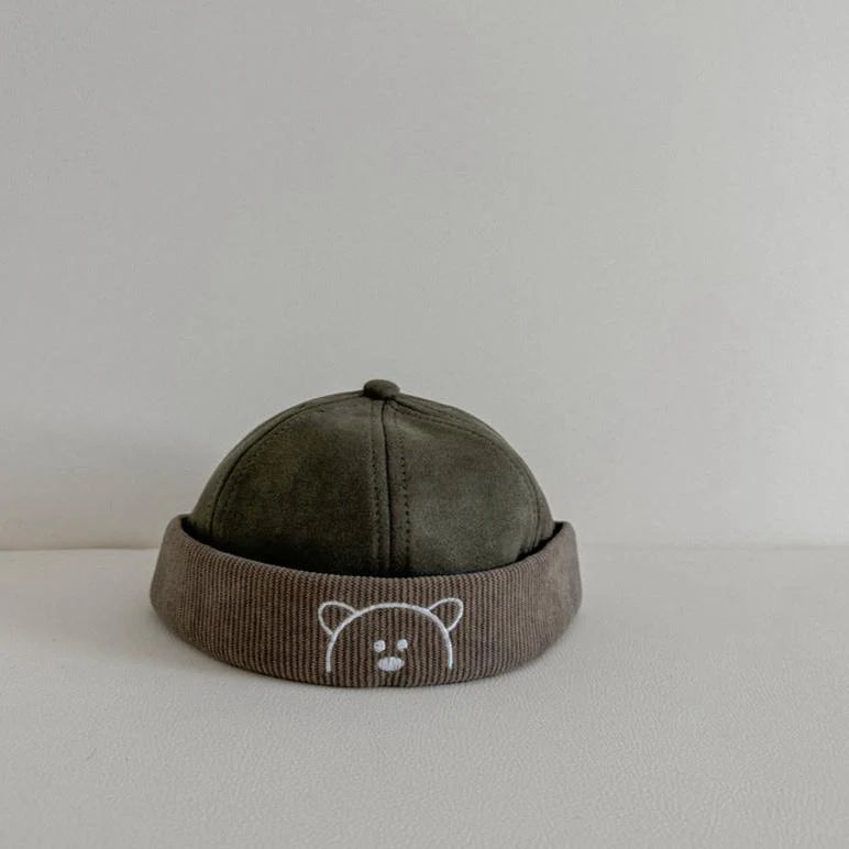 Green corduroy baby hat with bear embroidered band
