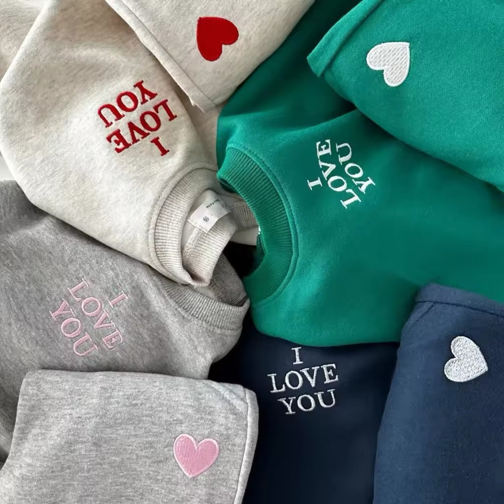 Close-up of I Love You embroidery and heart patches