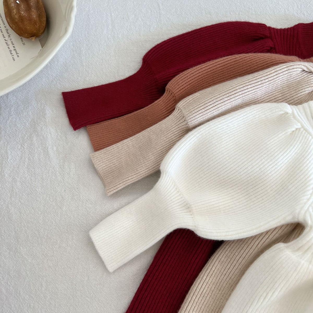 Close-up of puff sleeves on knit dresses